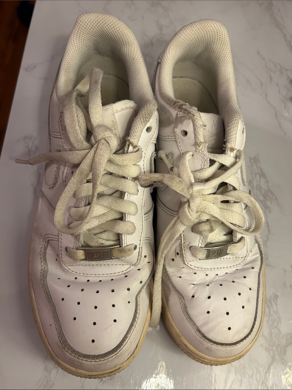 Woman’s White Leather Nike Sneakers
